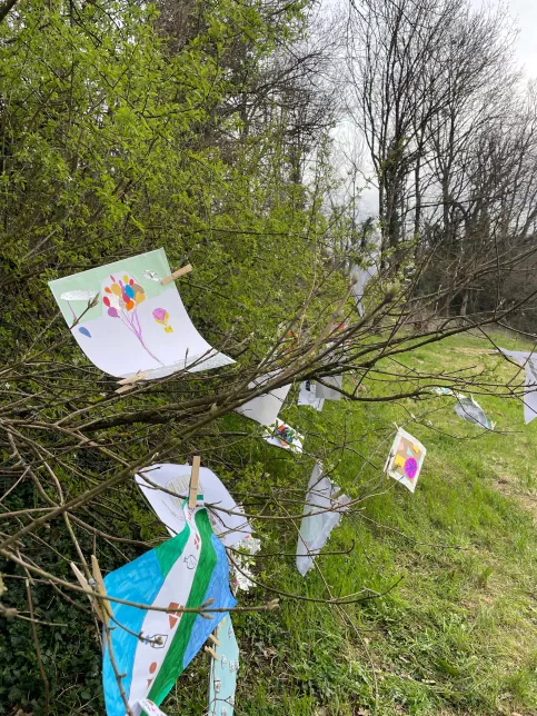 exposition de dessins dl'élèves dans les arbres du parc de l'école 